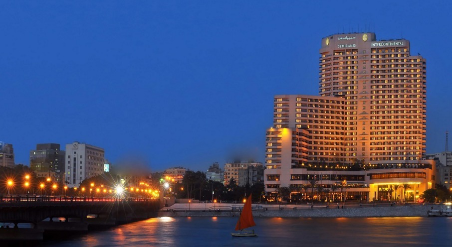 a building with a sailboat in the water