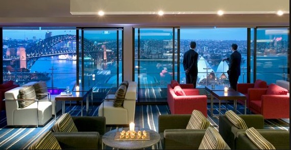 a man standing in a room with a view of a city