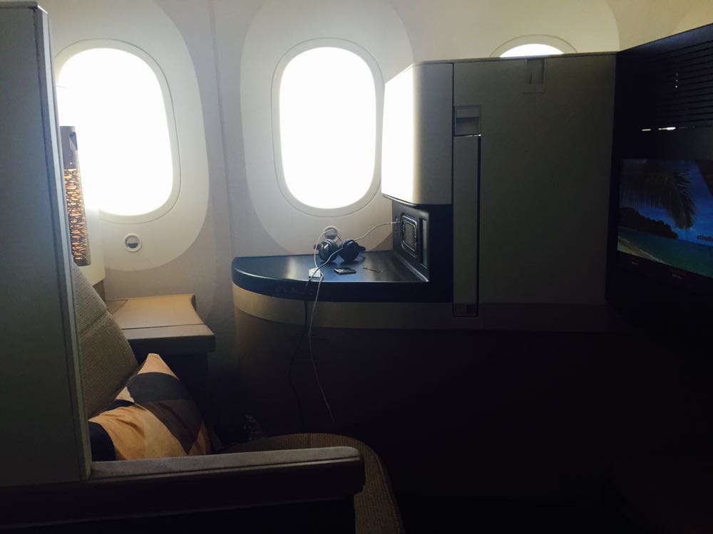 a seat with windows and a television