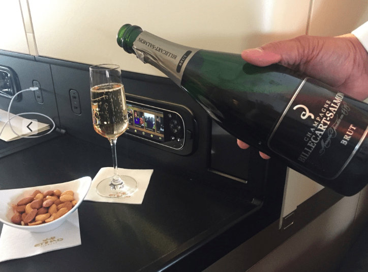 a hand holding a bottle of champagne