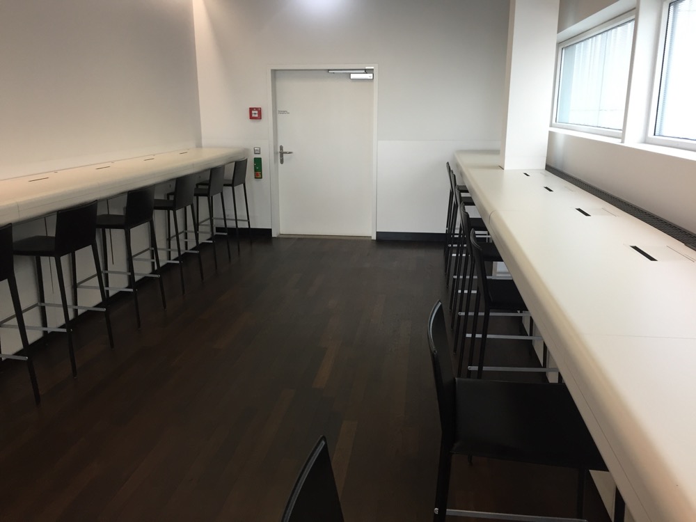 a room with long tables and chairs