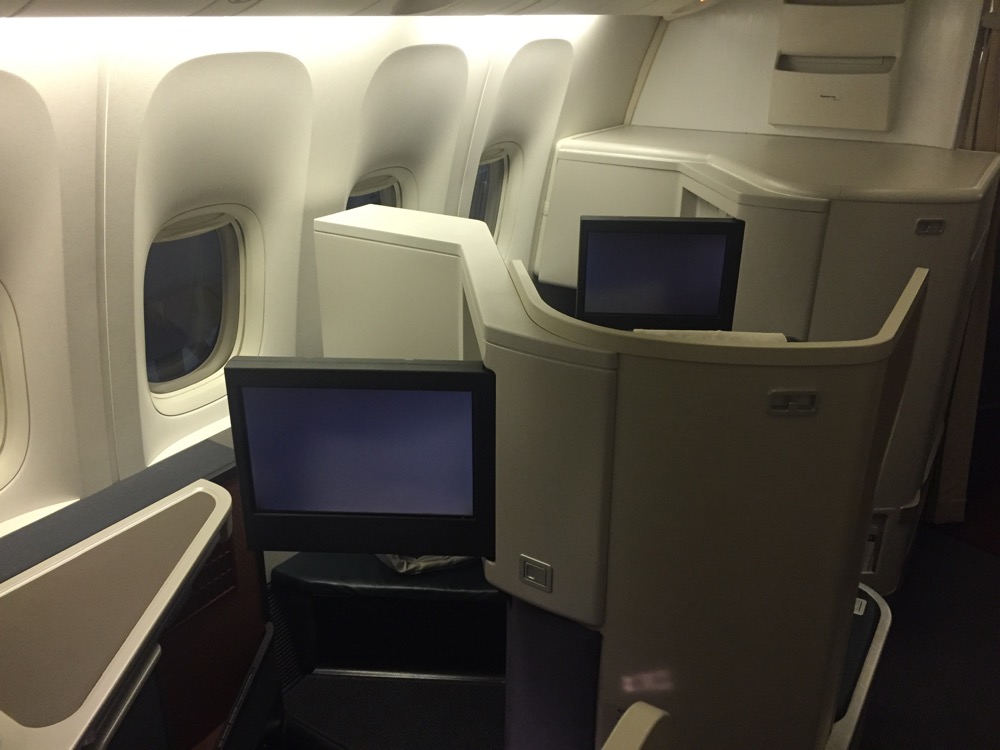 a row of monitors on an airplane