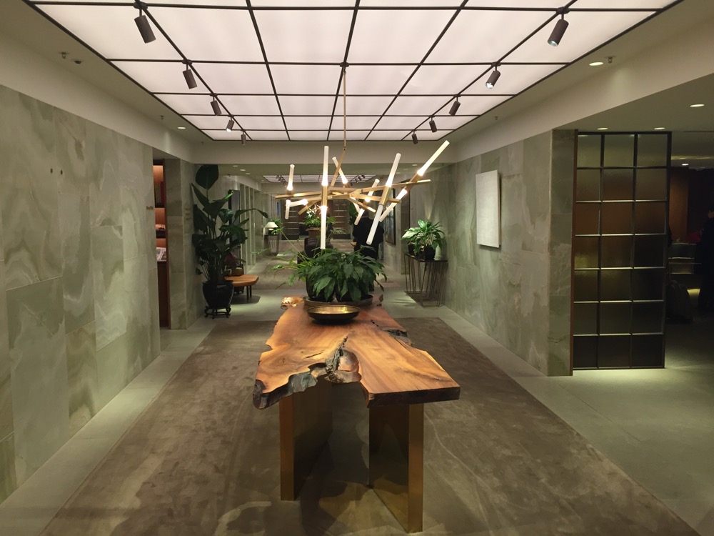 a long wooden table with a plant in it
