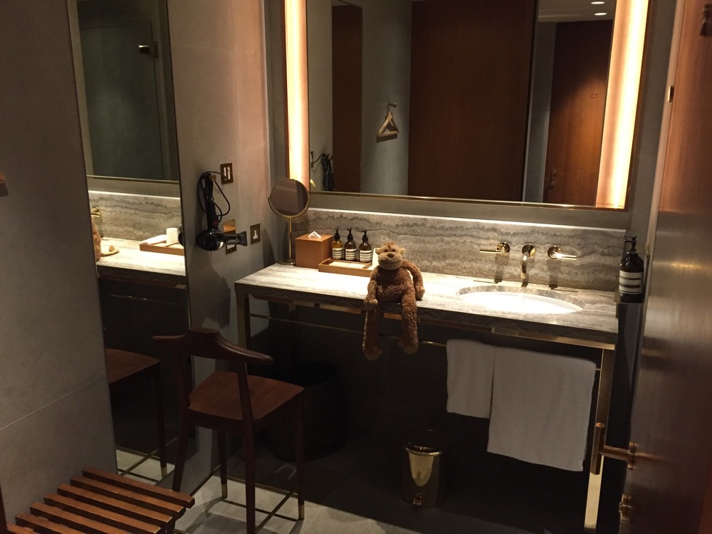 a bathroom with a teddy bear on the counter