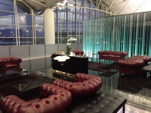 a room with red leather couches and a table