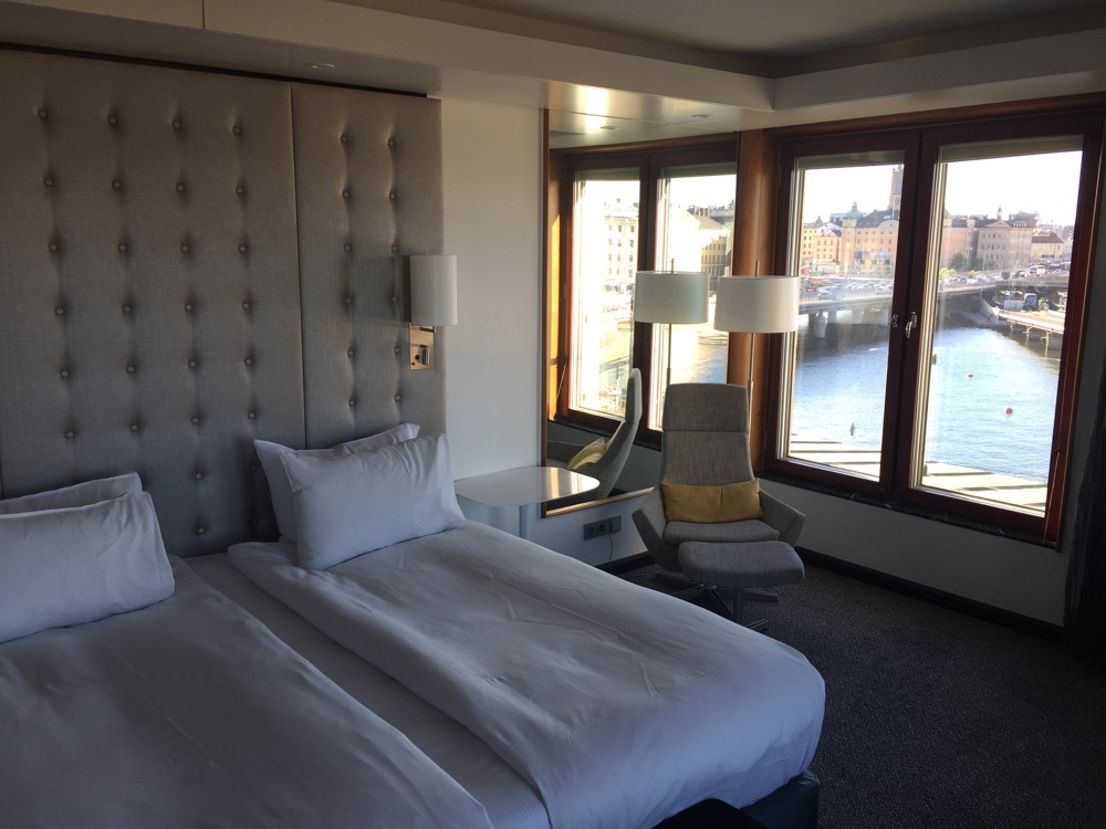 a room with a bed and a chair and a desk