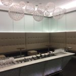 a bar with wine glasses and champagne bottles