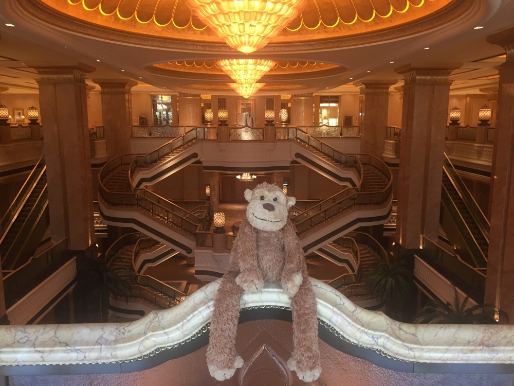a stuffed animal on a railing in a building