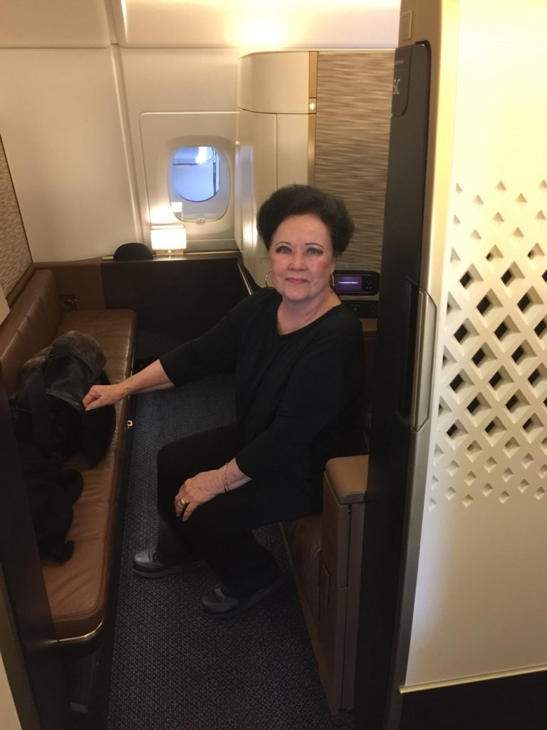 a woman sitting on a seat in a plane