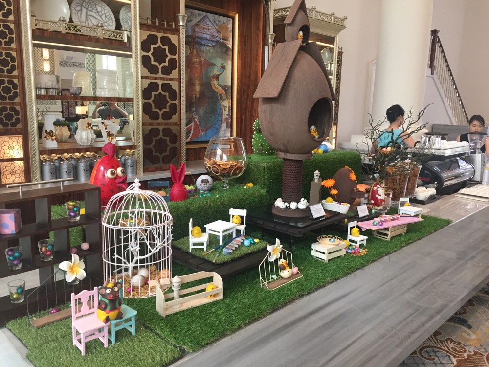 a display of a garden with a bird house and other objects
