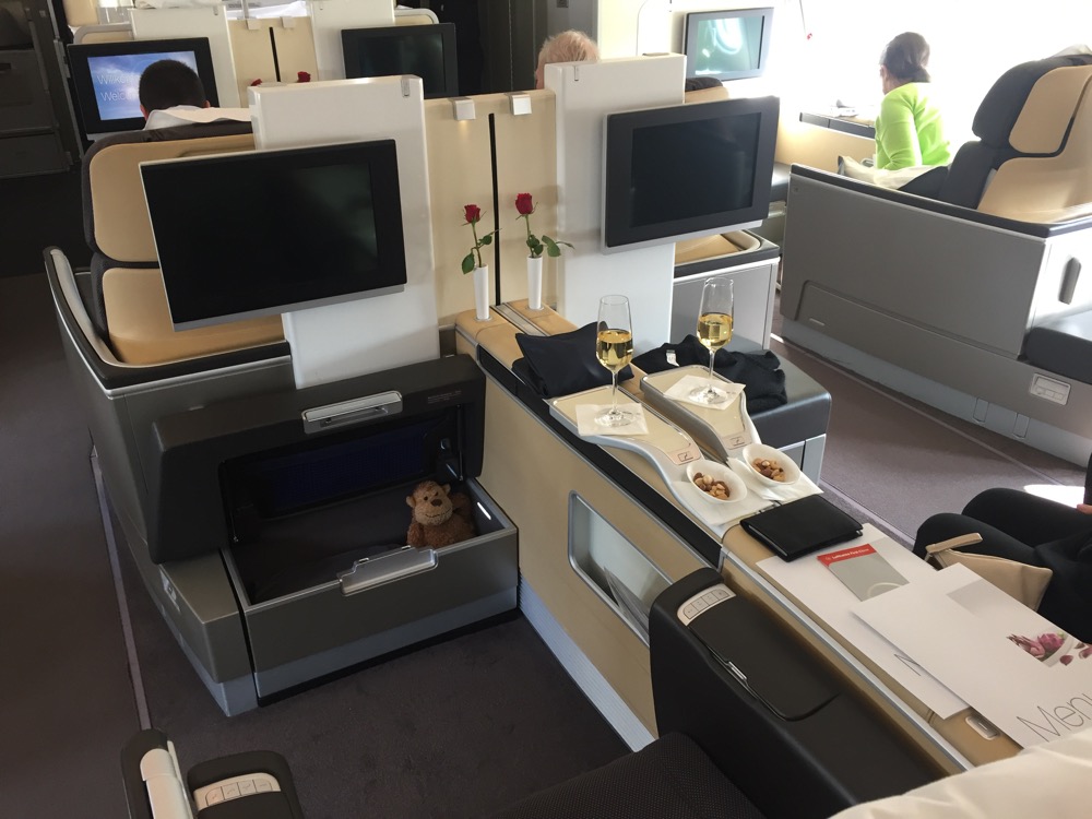 a small teddy bear in a small drawer in an airplane