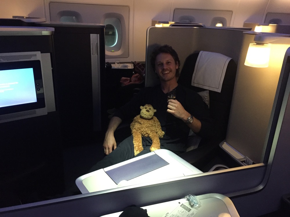 a man sitting in a chair with a stuffed animal