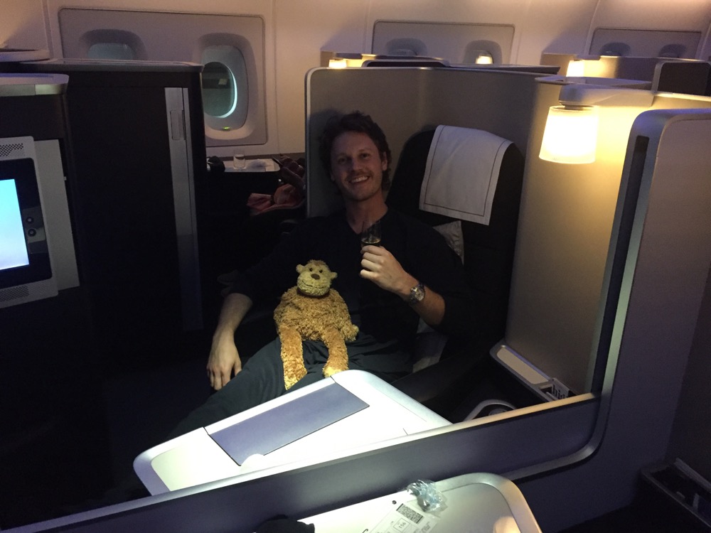 a man sitting in a chair with a stuffed animal