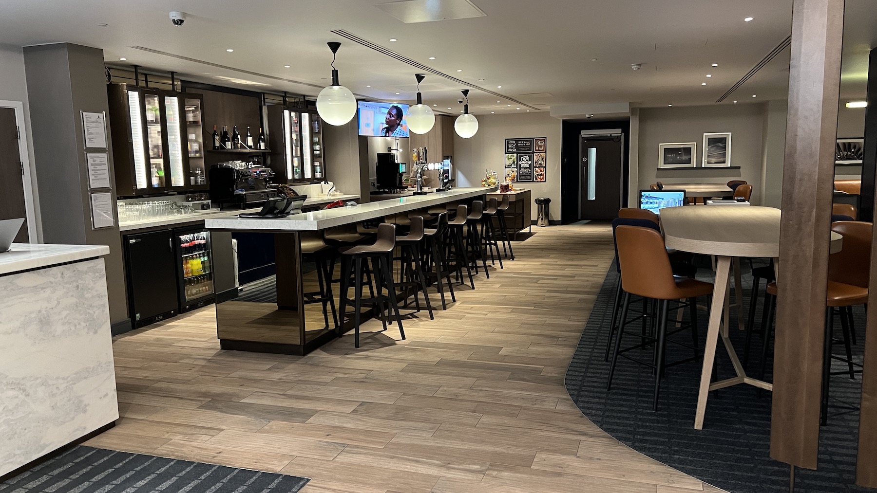a bar with chairs and a television