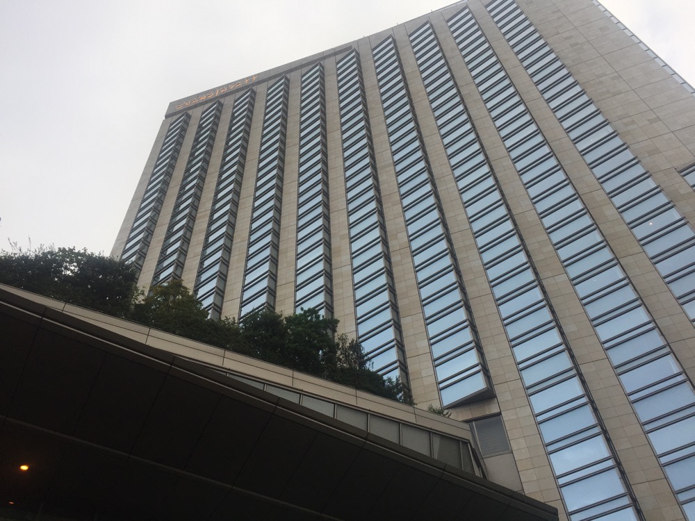 a tall building with trees on the side
