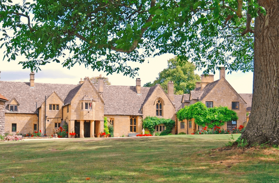 a large house with a lawn and trees