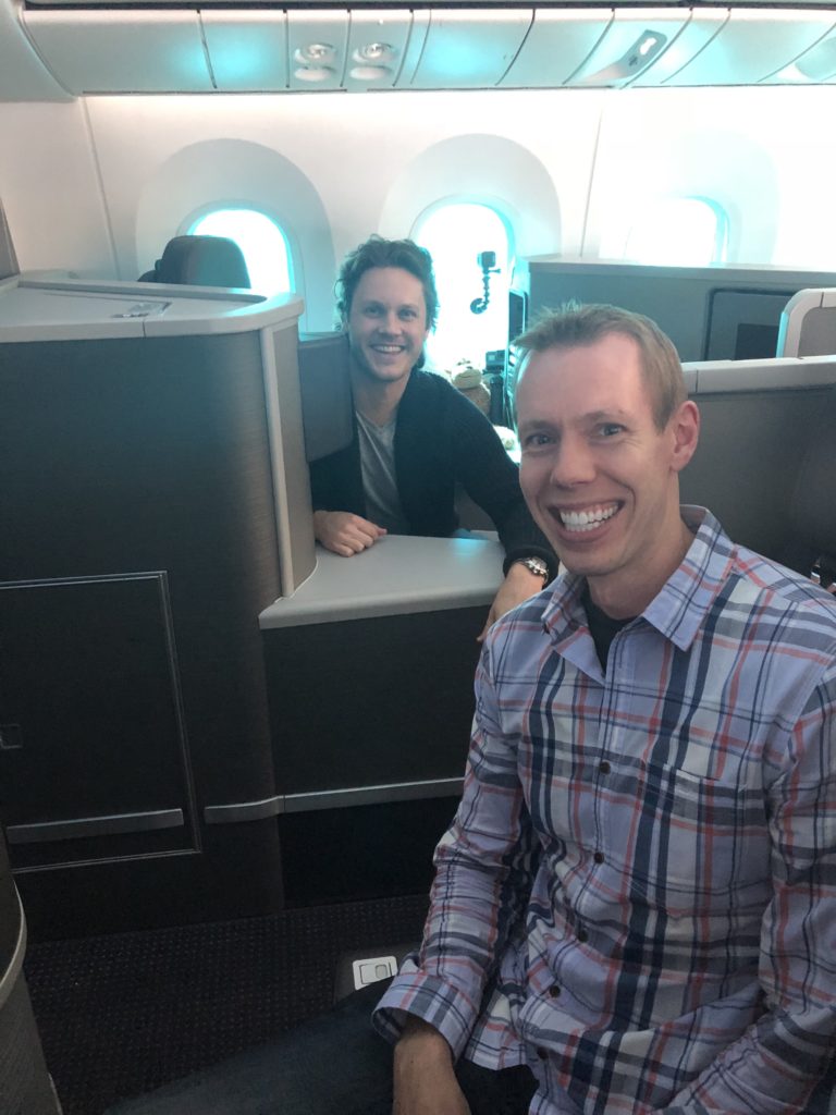 two men sitting in an airplane