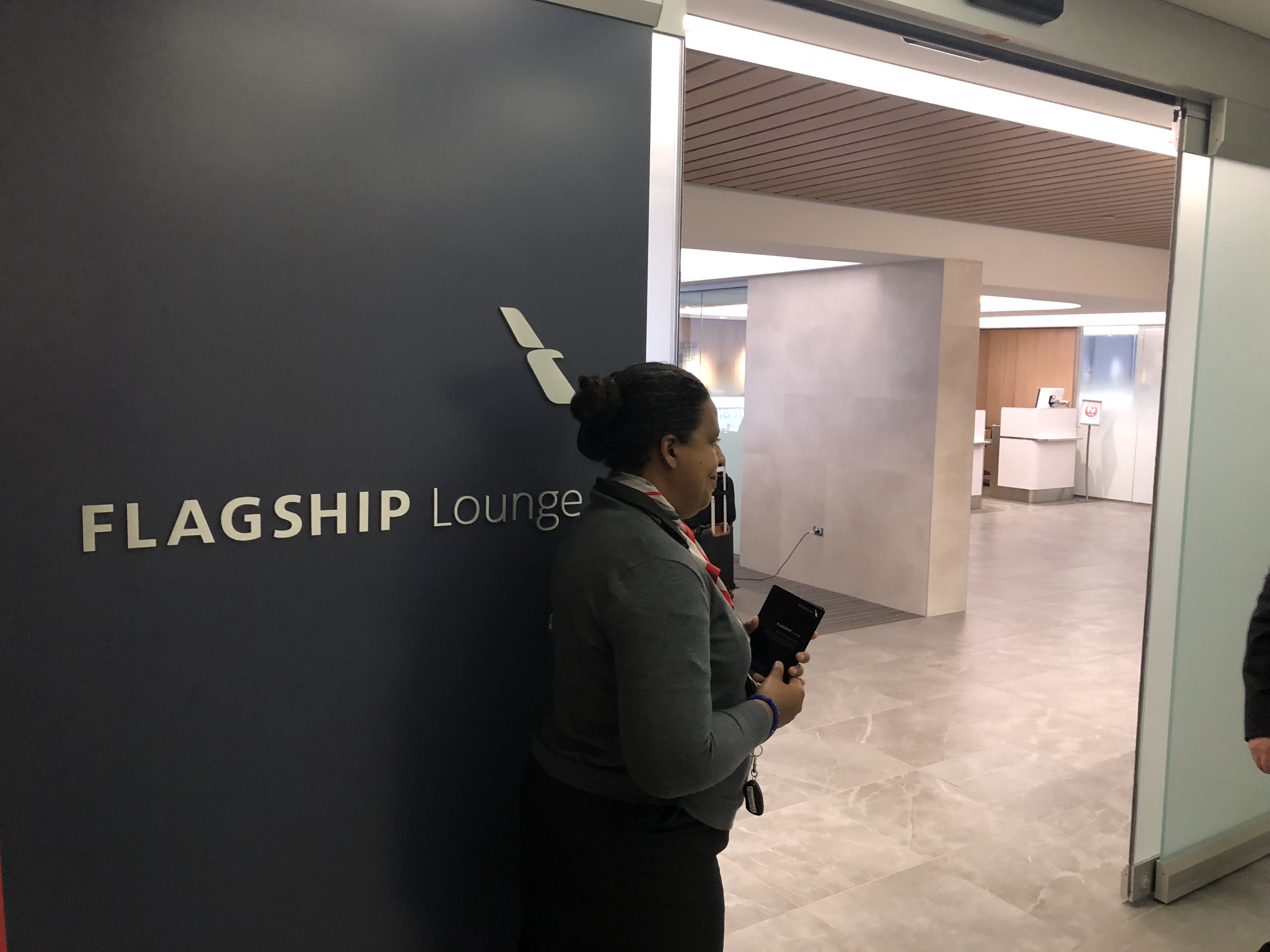 a woman standing next to a wall