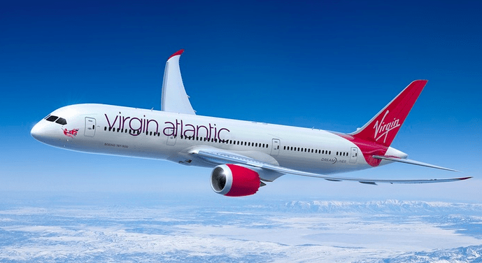 a white and red airplane flying in the sky