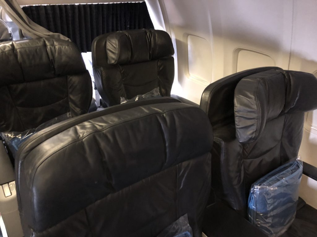 a row of black seats on an airplane