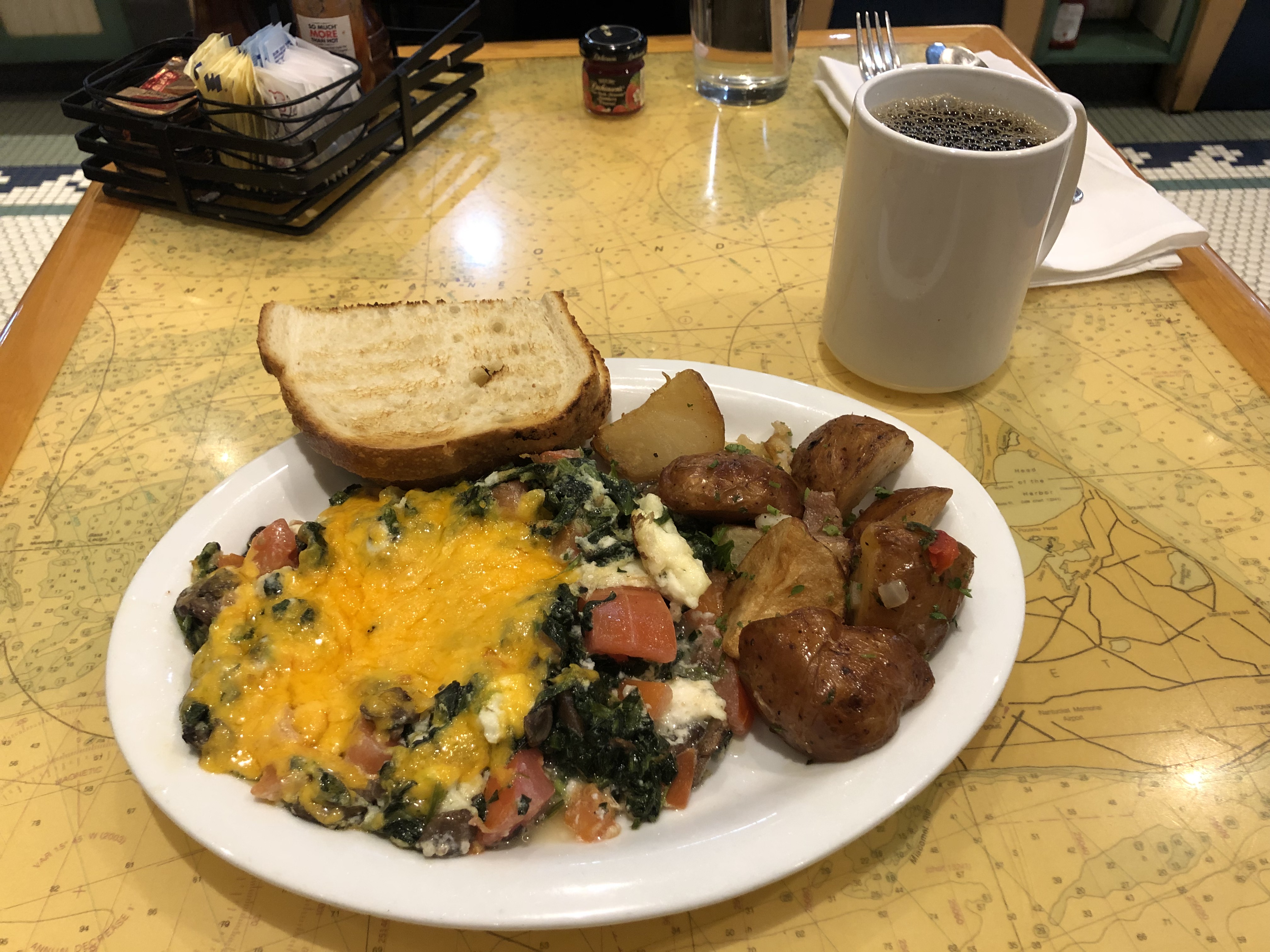 a plate of food and a cup of coffee