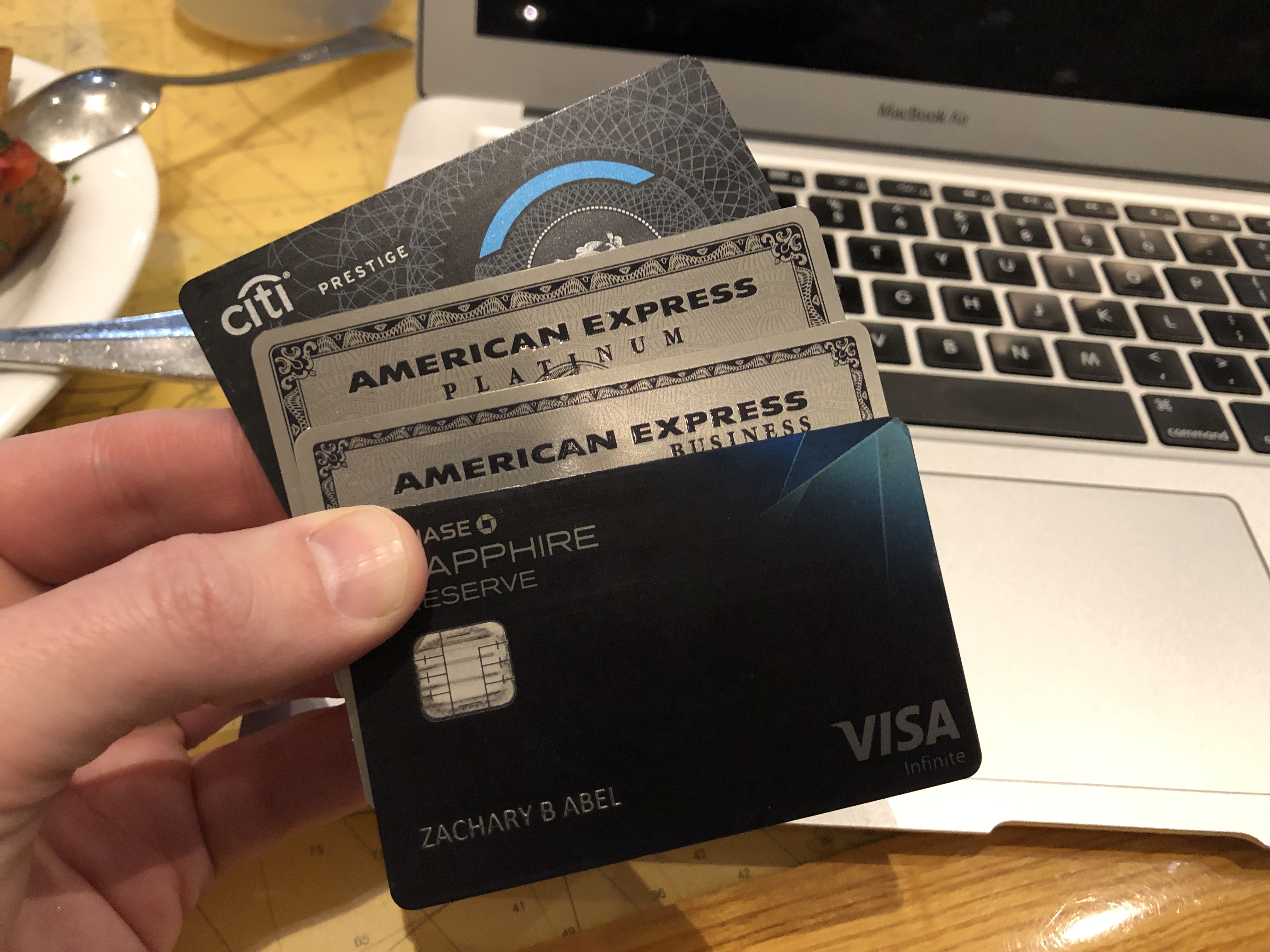 a hand holding credit cards