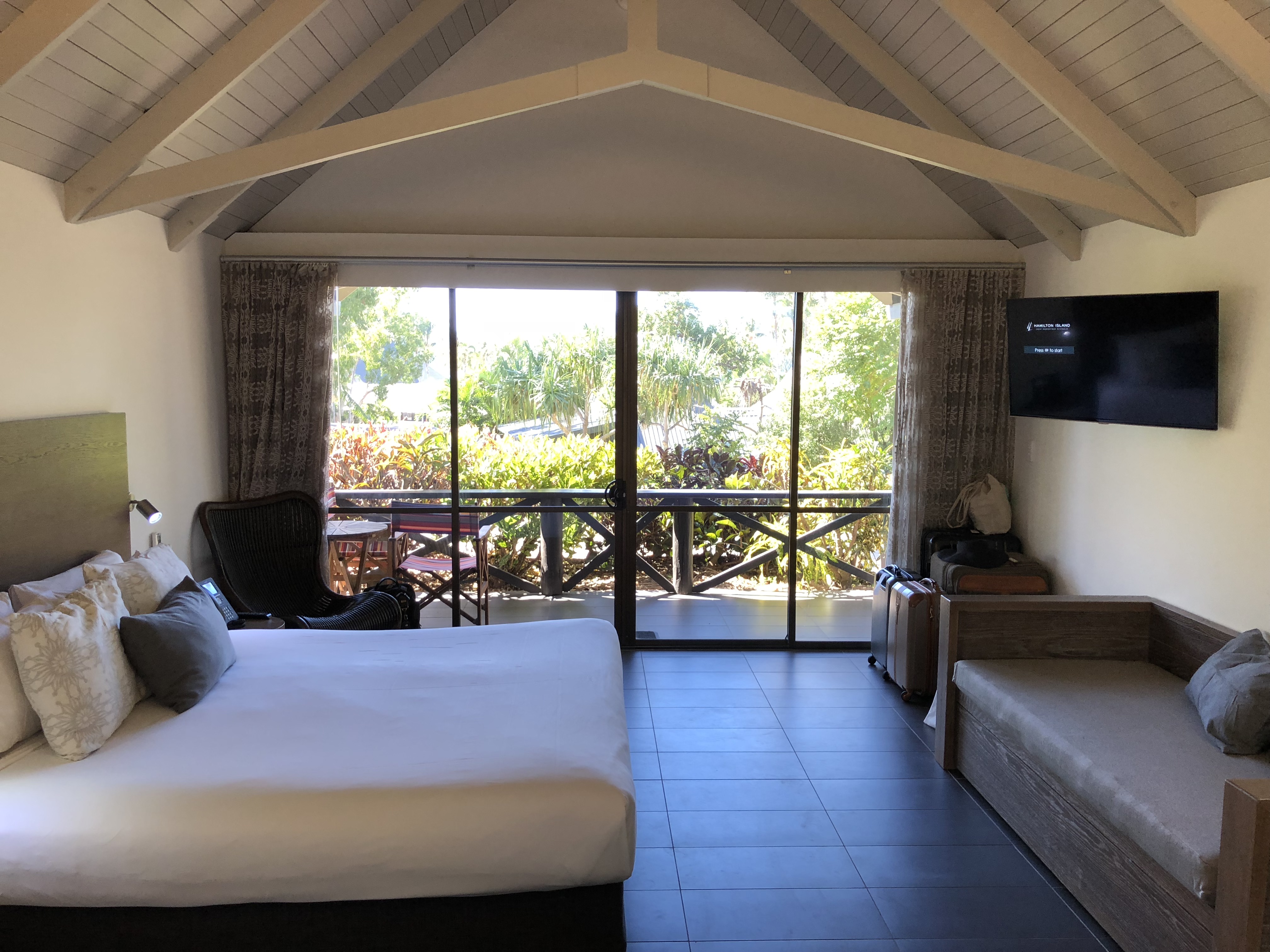 a room with a bed and a television