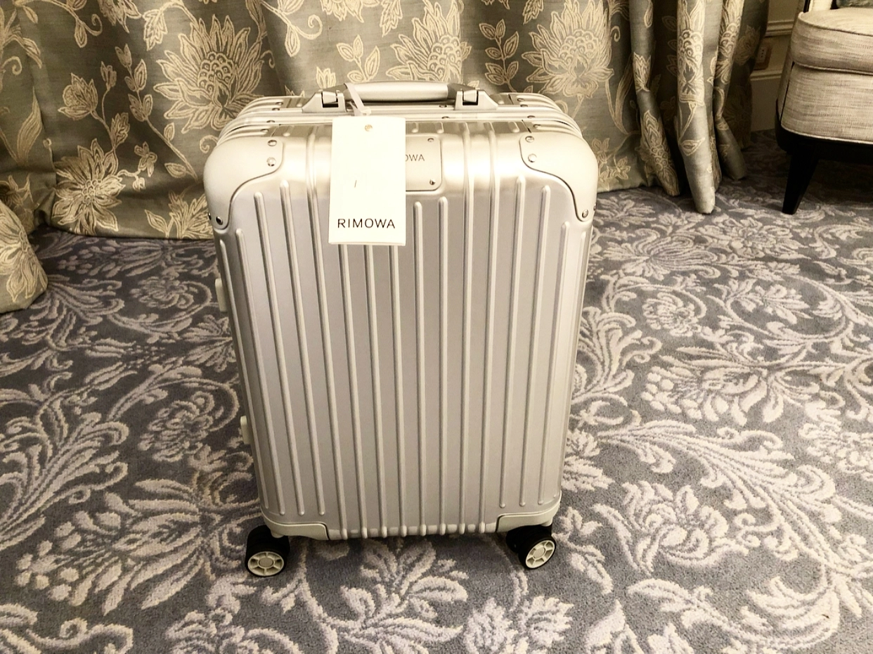 a silver suitcase on a carpet