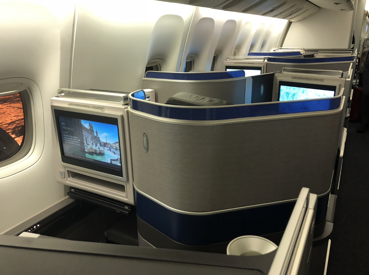 a row of seats with tvs on the side