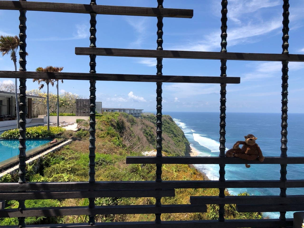 a stuffed animal on a fence overlooking the ocean