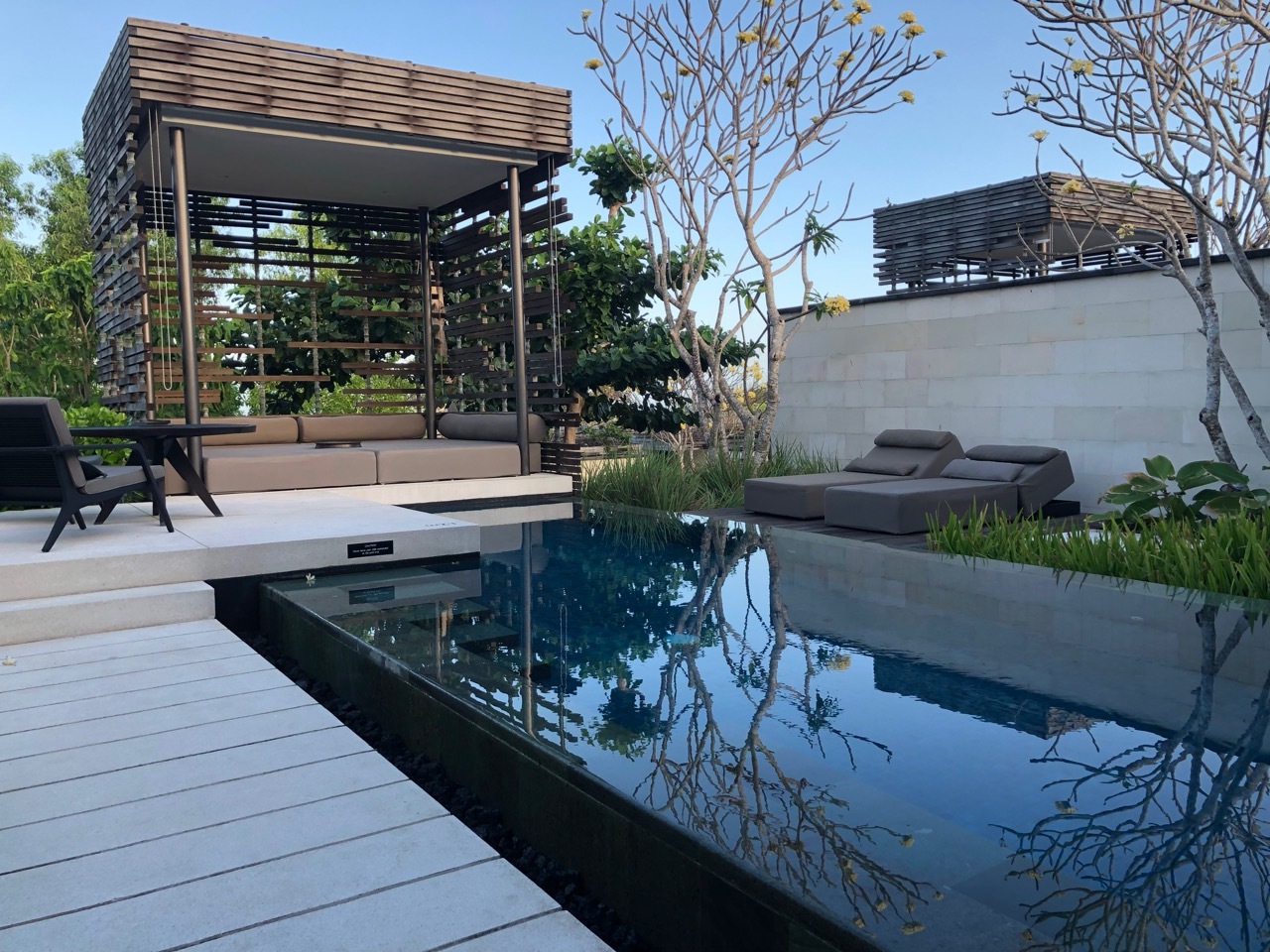 a pool with a deck and chairs