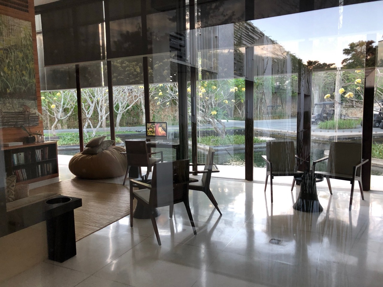 a room with a glass wall and a table and chairs