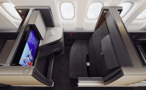 an airplane seat with a screen and a monitor