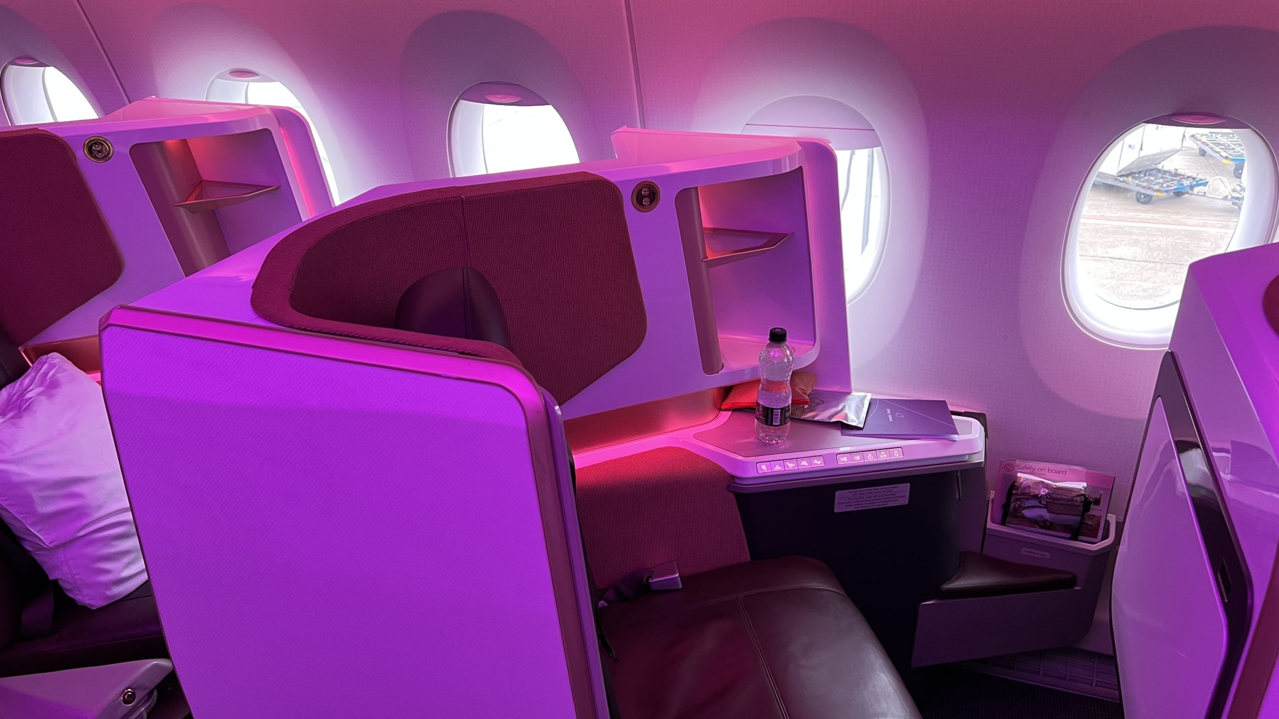 a pink and purple interior of an airplane