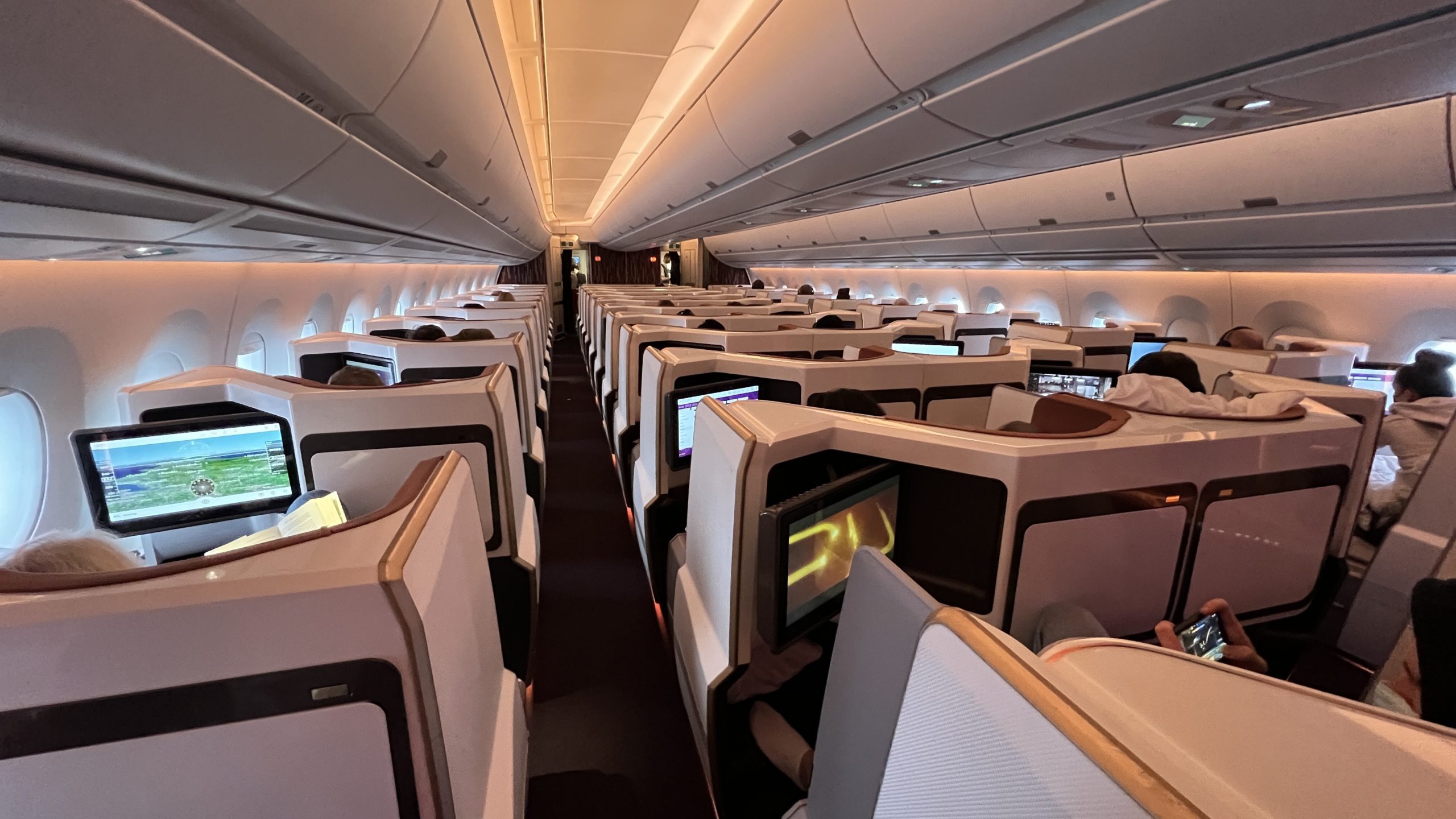an airplane with rows of seats and monitors