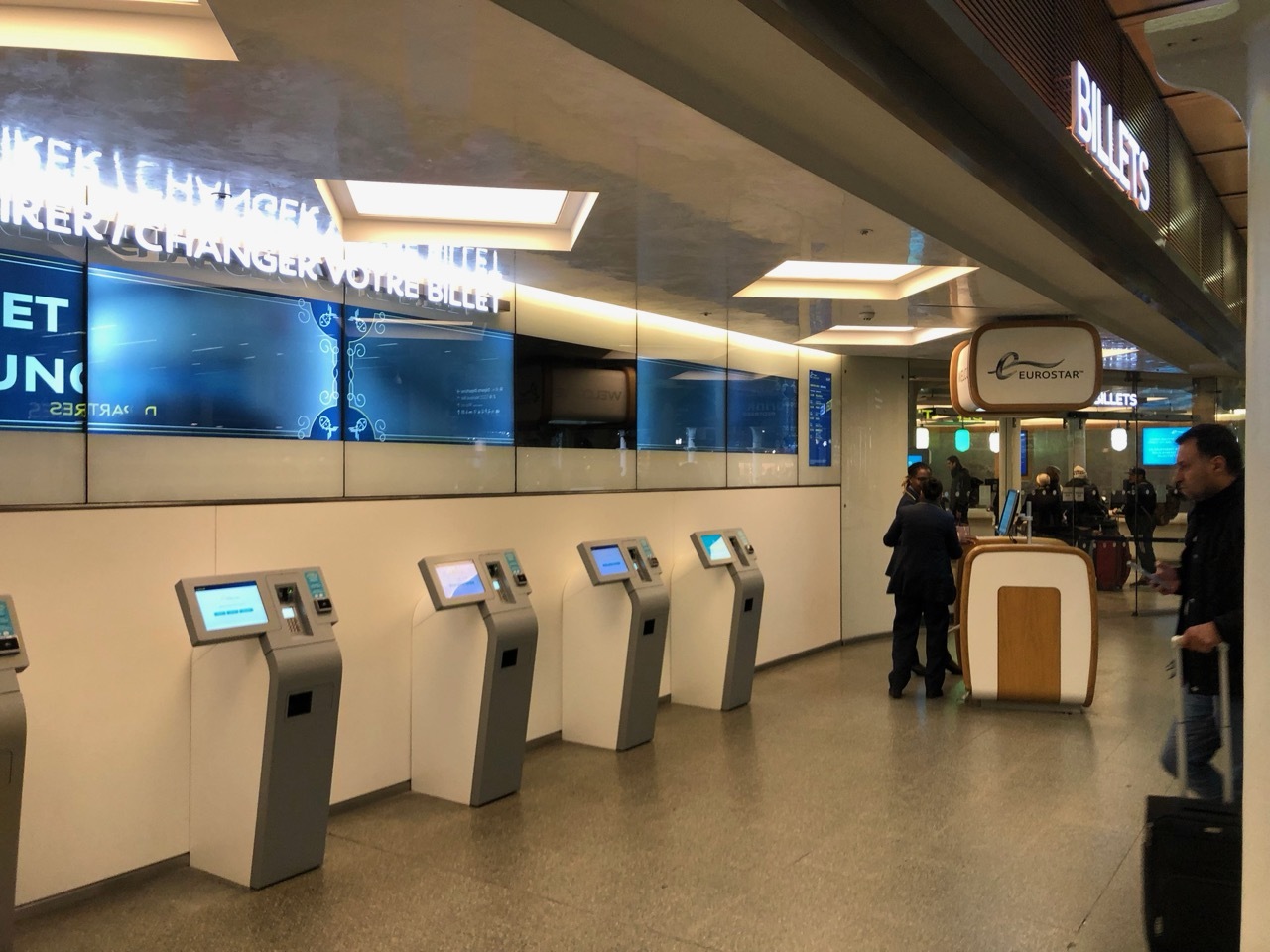 a group of people standing in front of a terminal