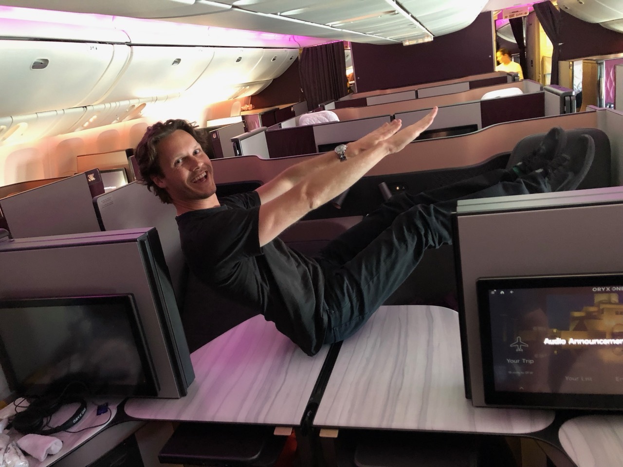 a man sitting on a desk with his legs raised