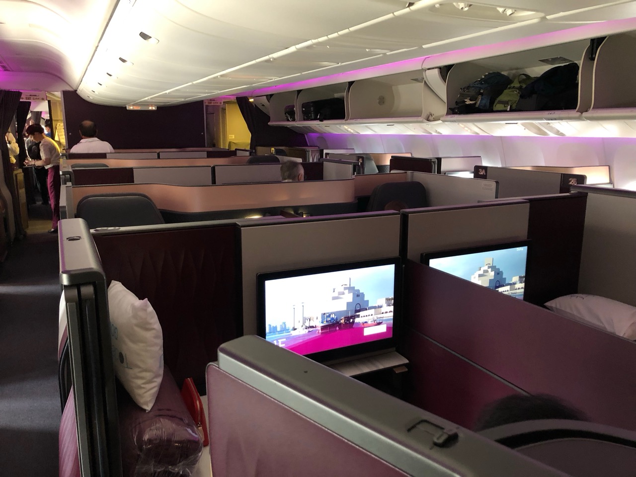 a row of seats with monitors on the side