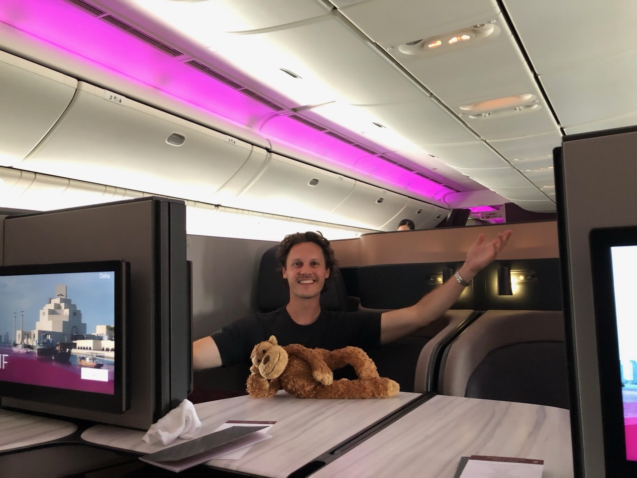 a man sitting at a table with a stuffed animal