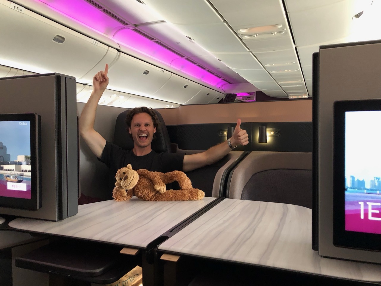 a man sitting at a table with a stuffed animal