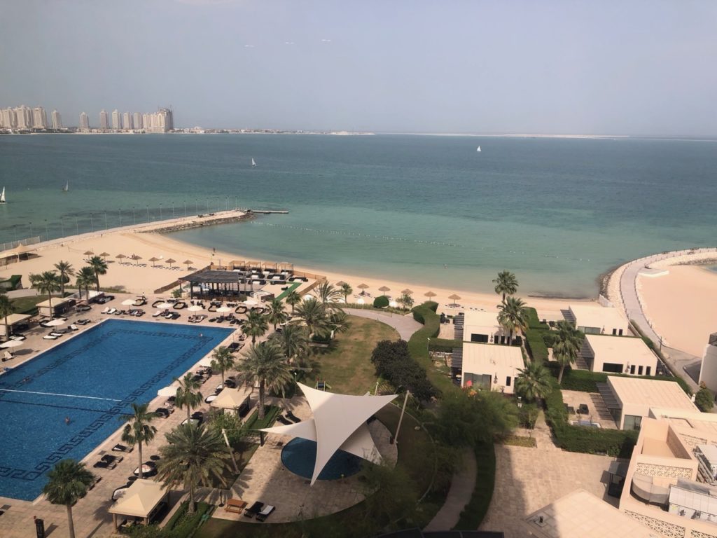 a beach with a body of water and a large body of water