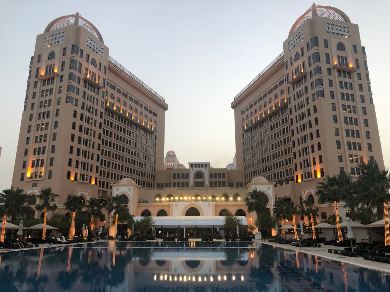 a large building with a pool in front of it