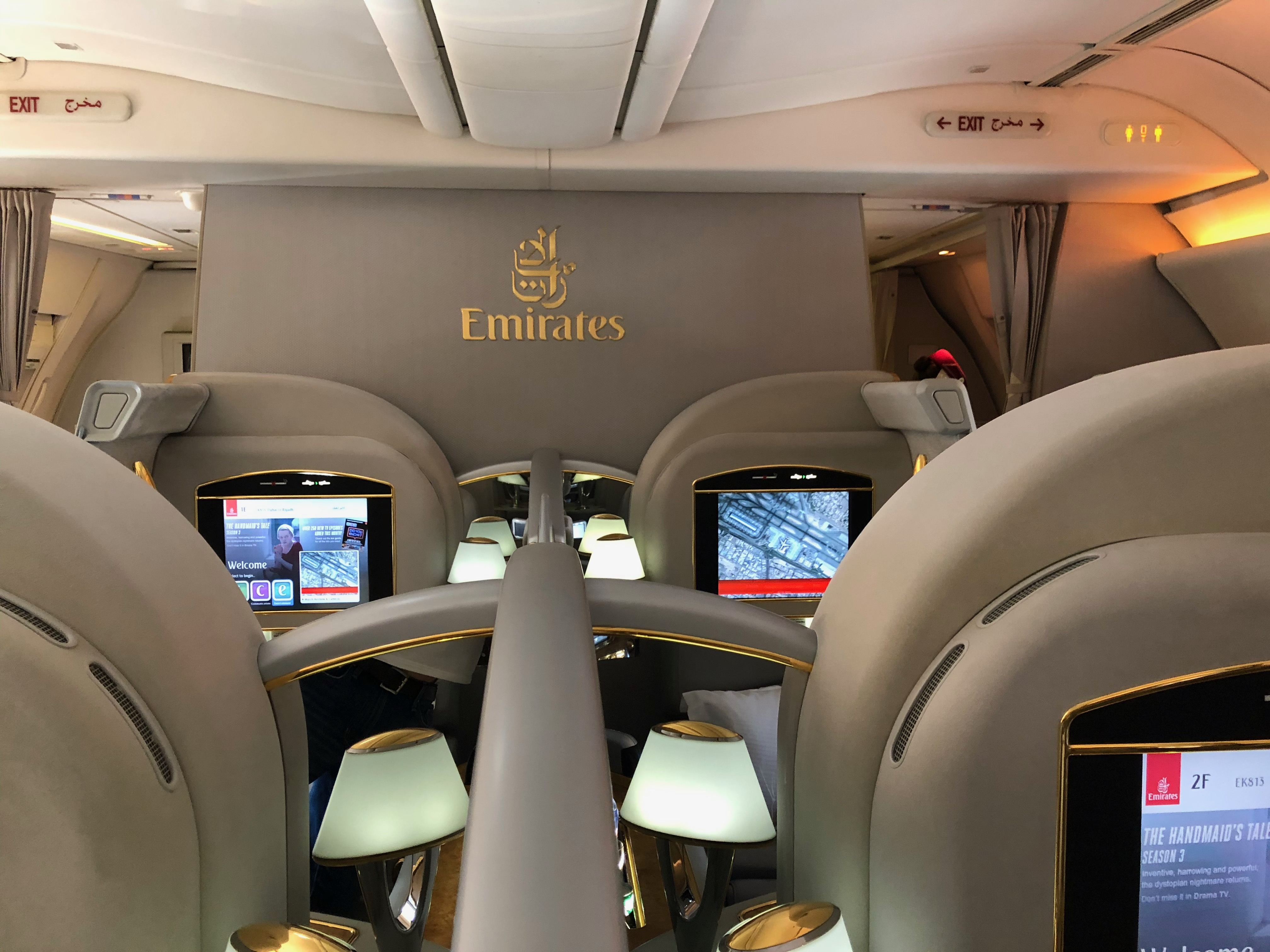 the inside of an airplane with a screen on the wall