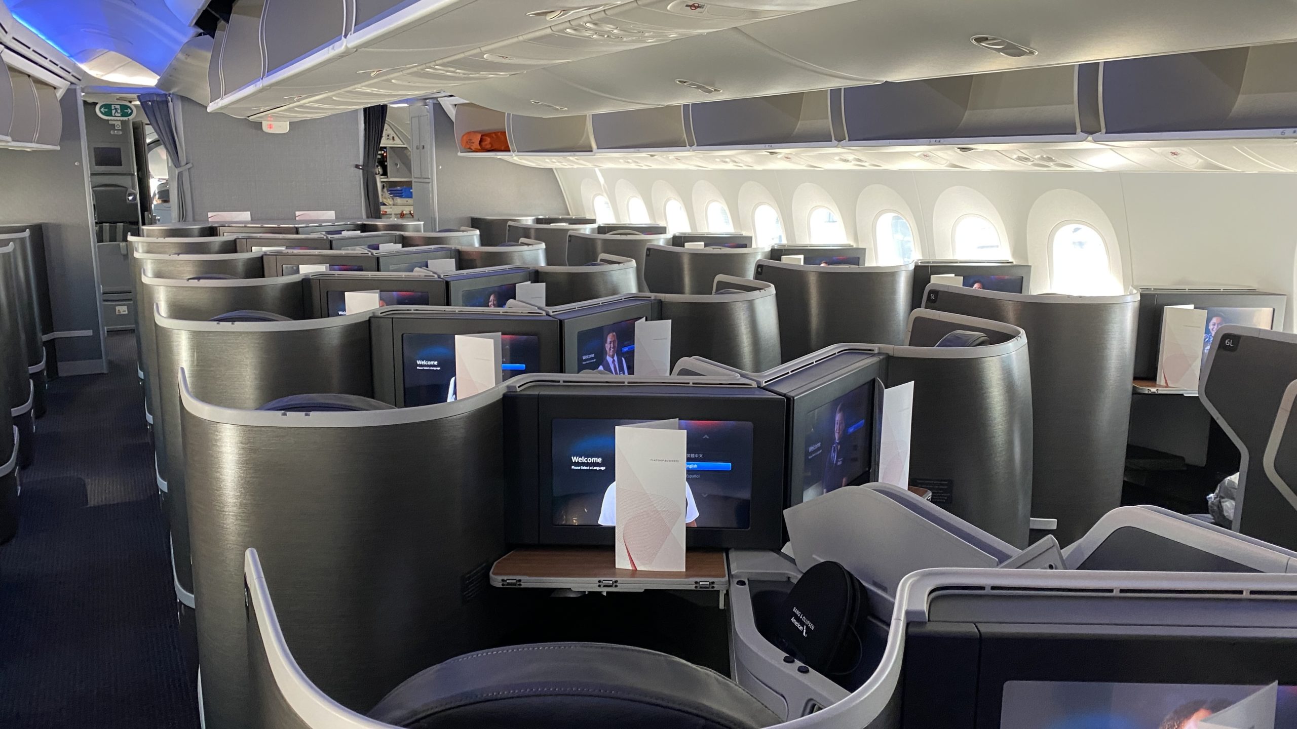 a row of seats with monitors on it