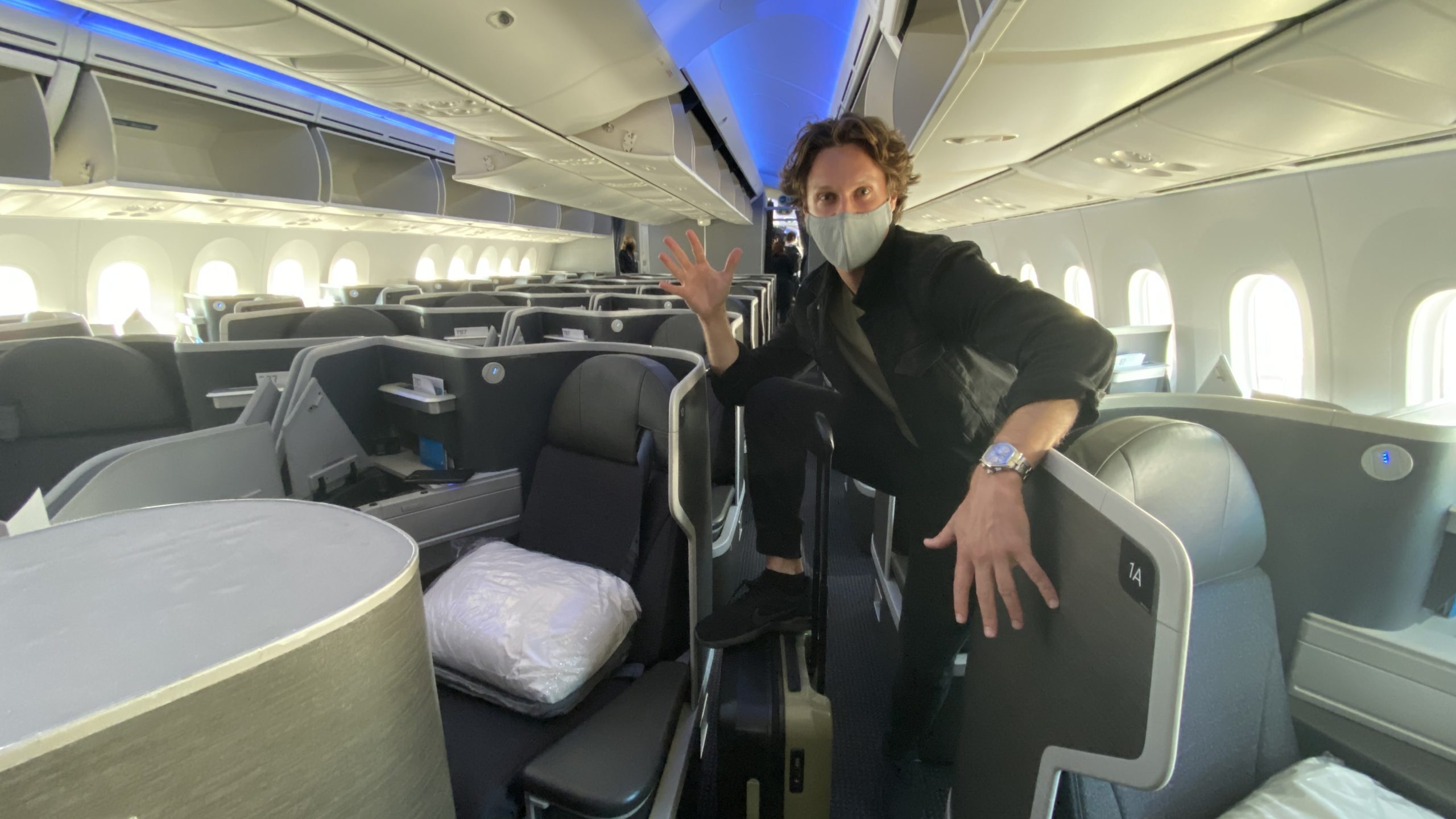 a man wearing a mask on an airplane