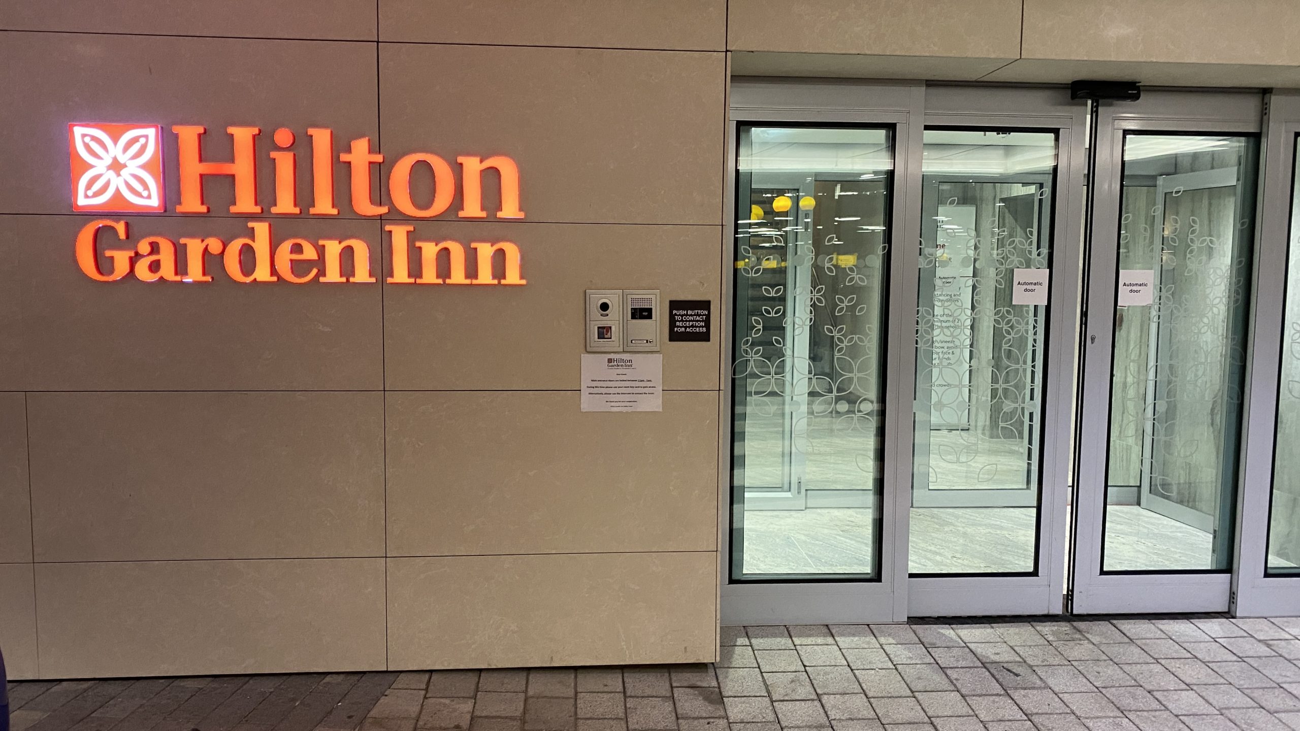 a building with glass doors and a sign