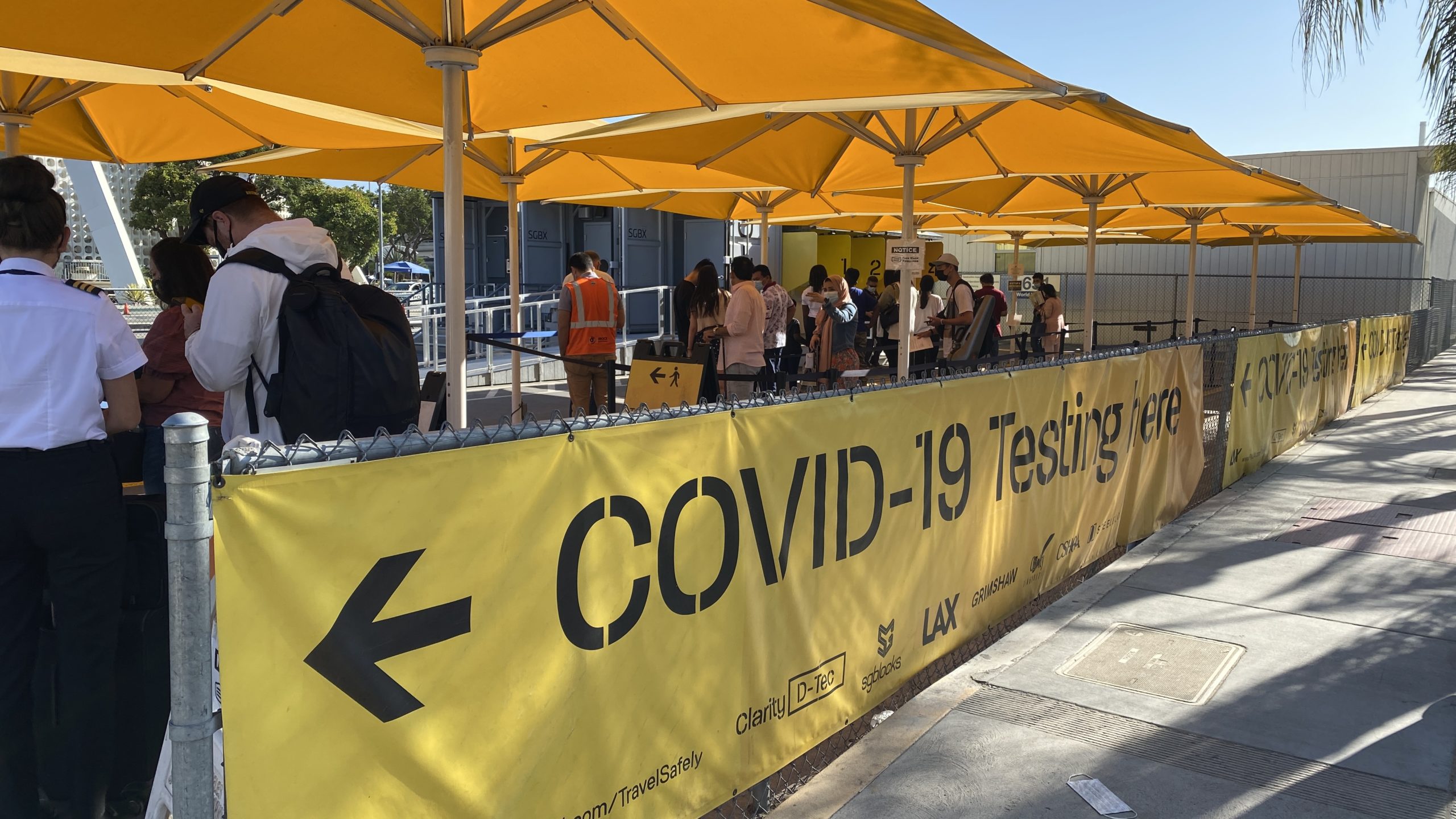 a group of people standing under a yellow banner