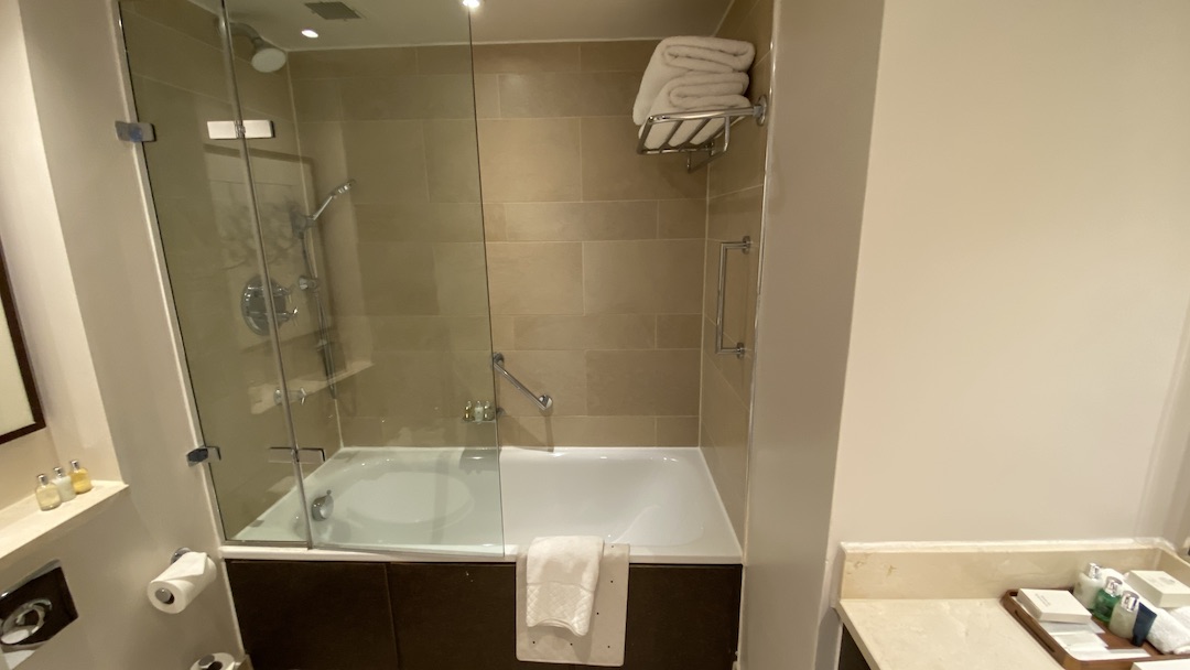 a bathroom with a glass shower door