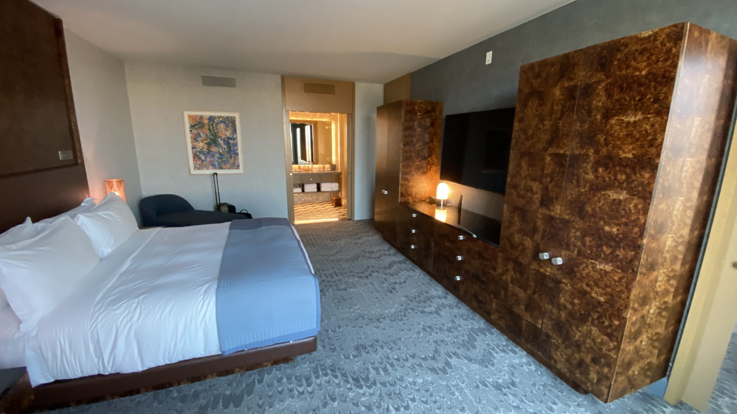 a room with a bed and a television