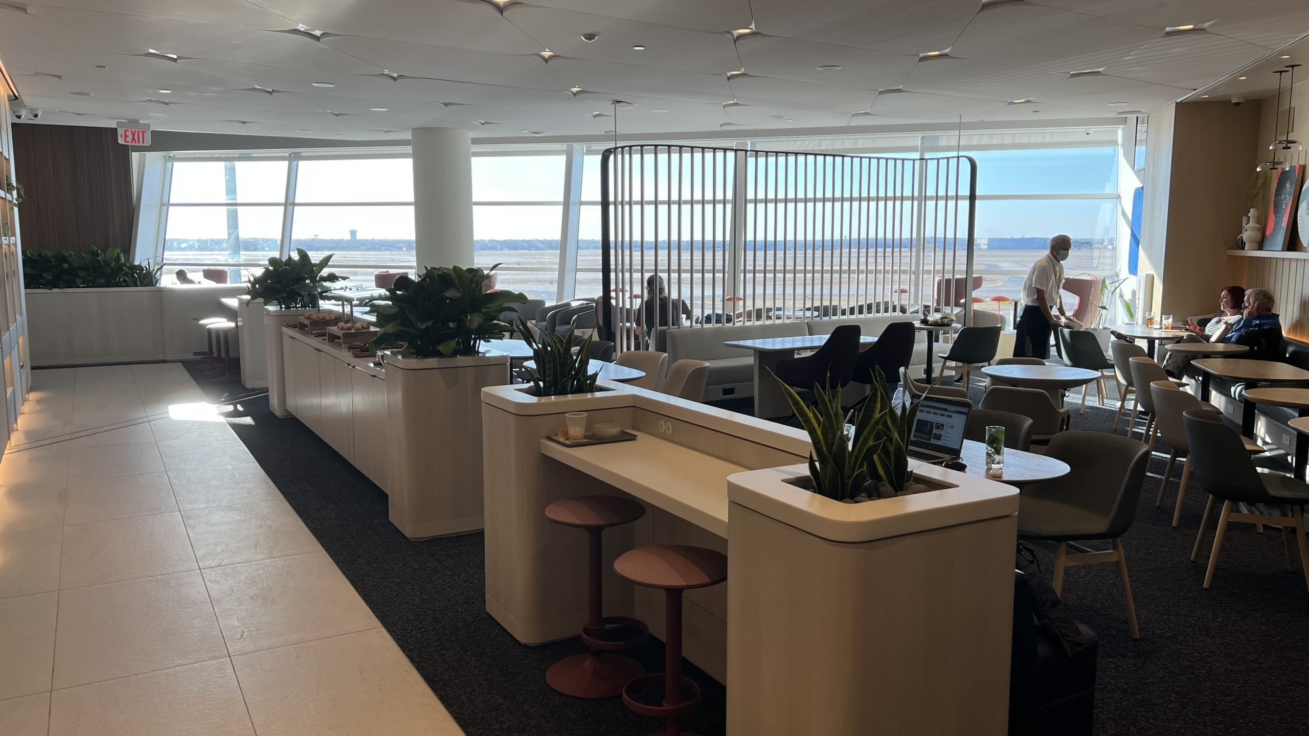 a room with tables and chairs and a window